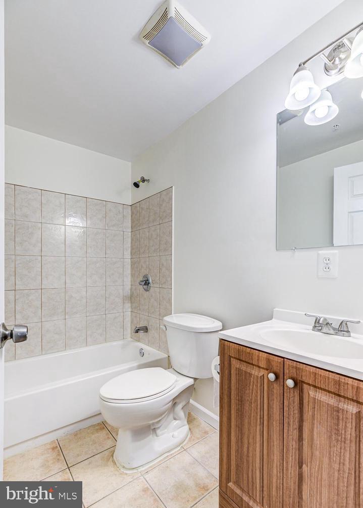 7520 Maury Road Baltimore, MD 21244 - Photo 17 of 29 a bathroom with a toilet a sink a mirror and bathtub
