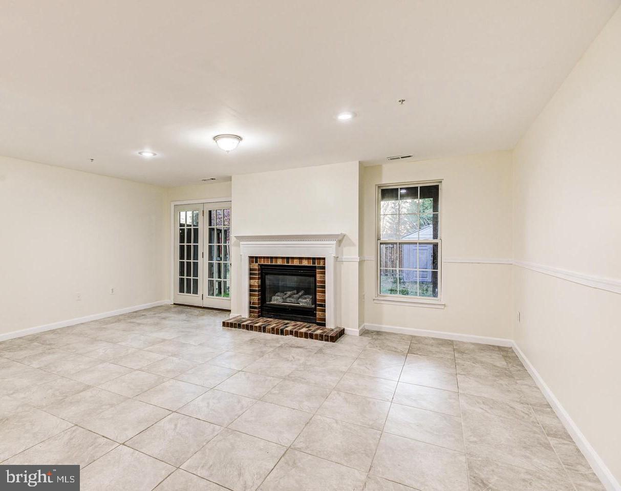 7520 Maury Road Baltimore, MD 21244 - Photo 22 of 29 an empty room with fireplace and windows
