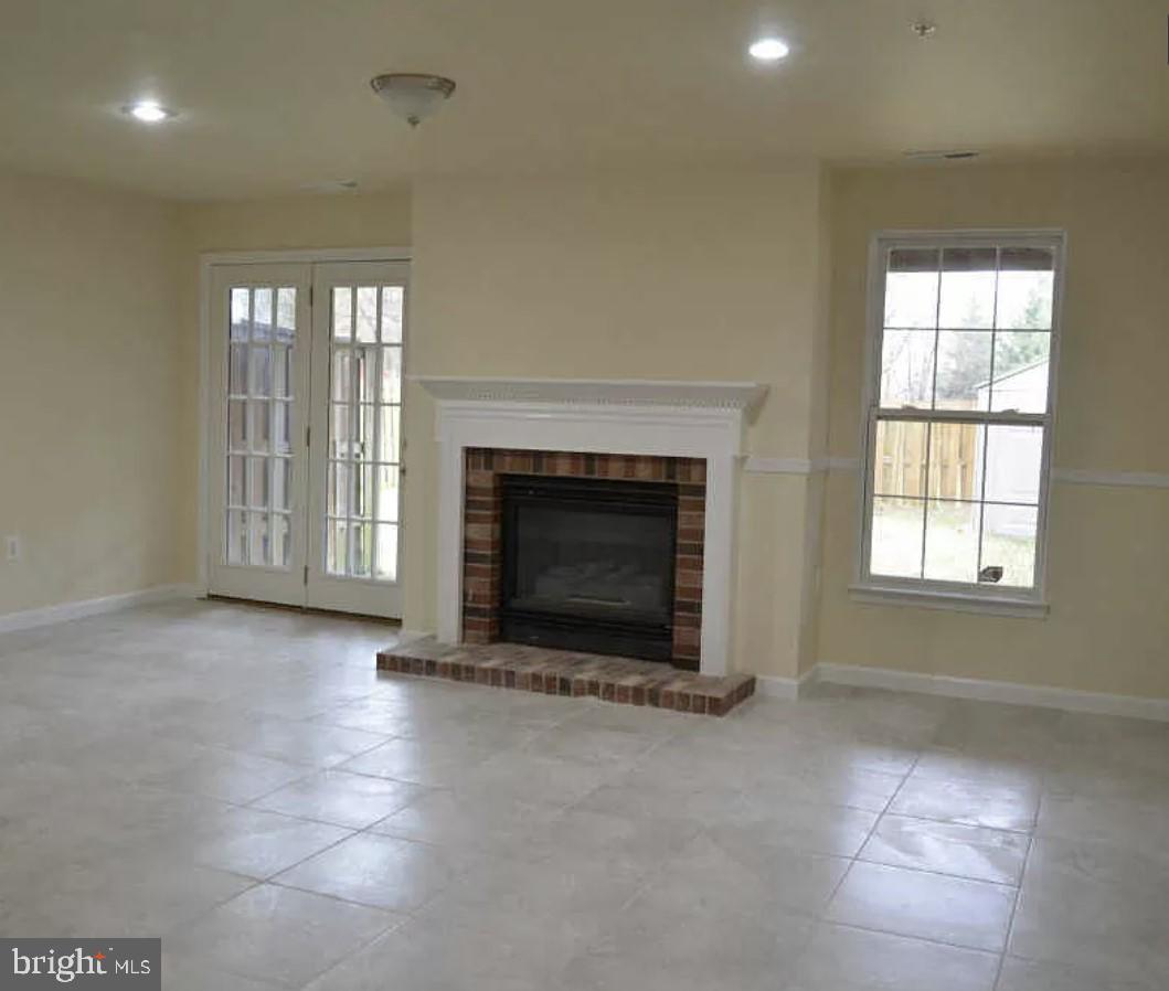 7520 Maury Road Baltimore, MD 21244 - Photo 23 of 29 an empty room with fireplace and windows
