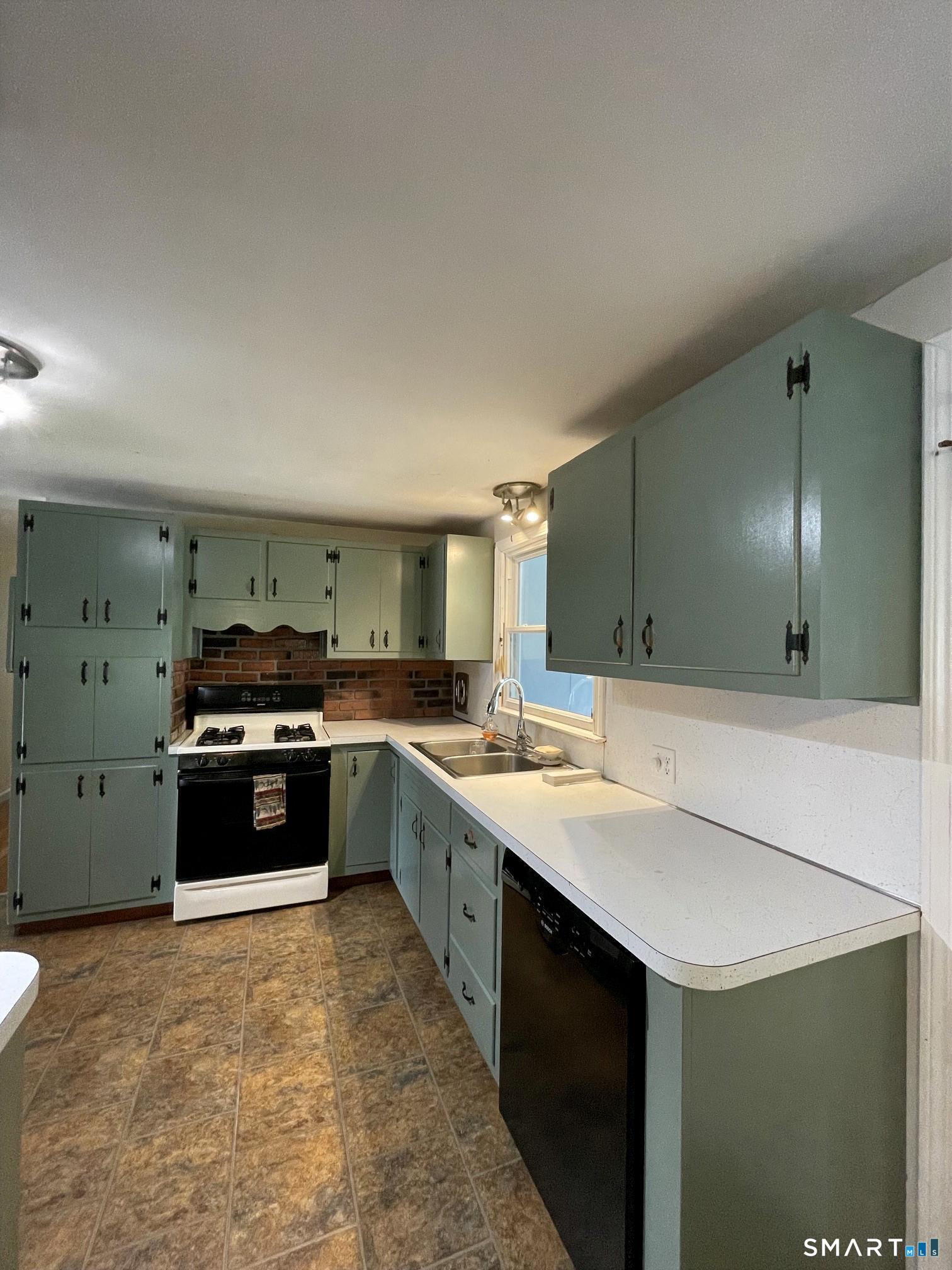 18 Old South Cove Road Old Saybrook, CT 06475 - Photo 15 of 40 a kitchen with stainless steel appliances granite countertop a stove a sink and a refrigerator