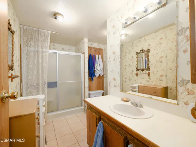 a bathroom with a sink double vanity and shower
