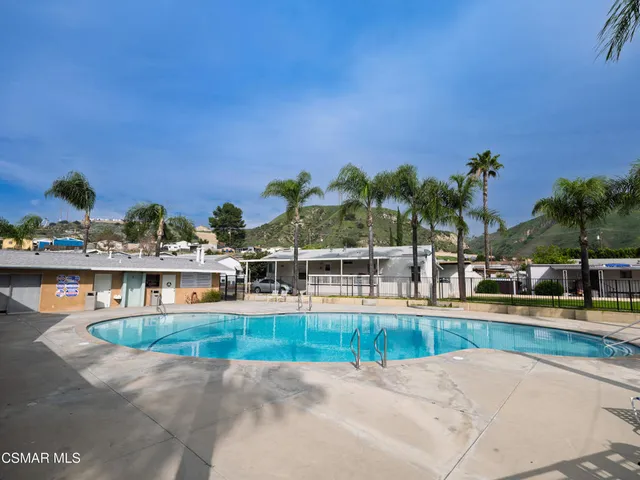 a view of a swimming pool with an outdoor seating