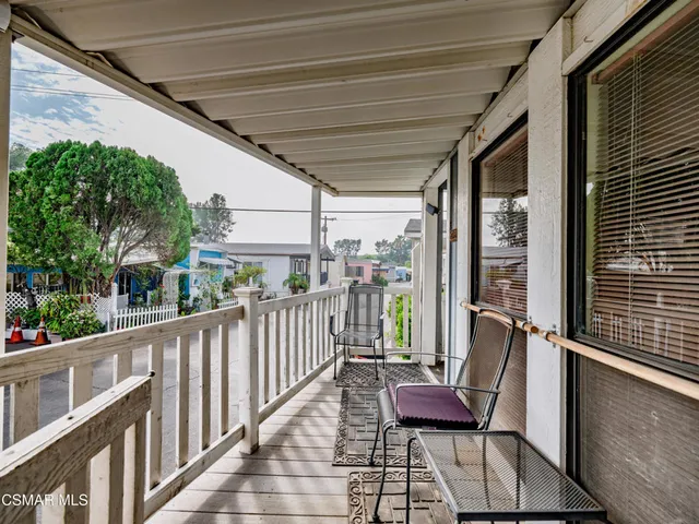a view of a porch with furniture and a yard