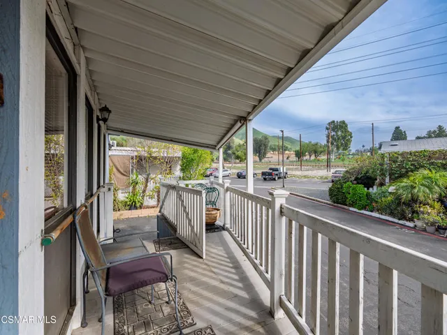 a view of a porch with wooden floor and outdoor seating