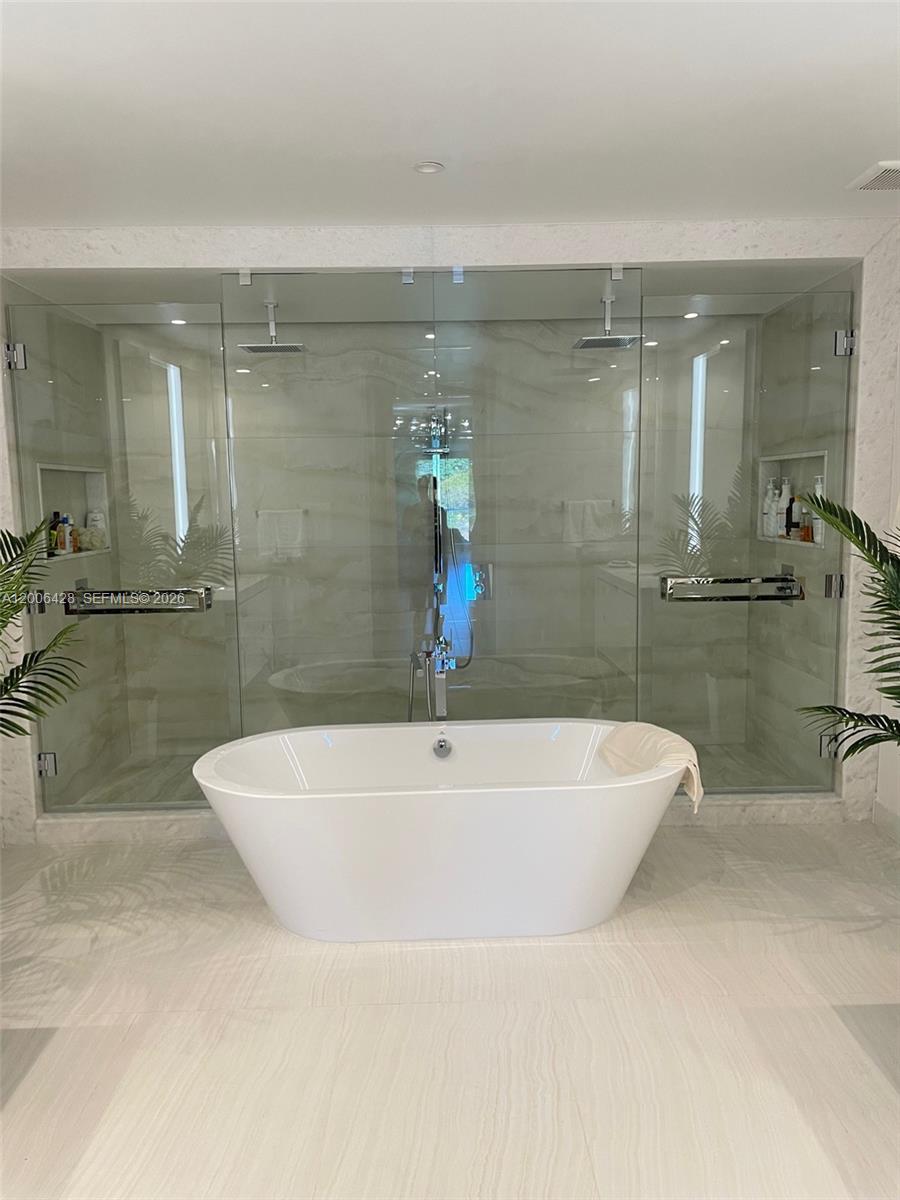 220 Southeast Mizner Boulevard, Unit 321 Boca Raton, FL 33432 - Photo 11 of 24 a bathroom with a bathtub and shower