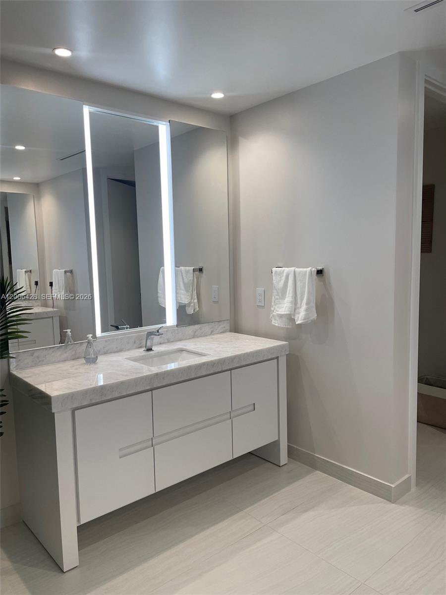 220 Southeast Mizner Boulevard, Unit 321 Boca Raton, FL 33432 - Photo 12 of 24 a bathroom with a double vanity sink and a mirror