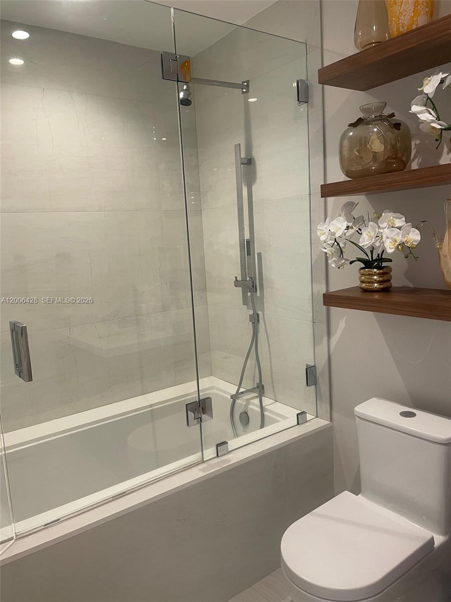 220 Southeast Mizner Boulevard, Unit 321 Boca Raton, FL 33432 - Photo 15 of 24 a bathroom with a toilet and a shower