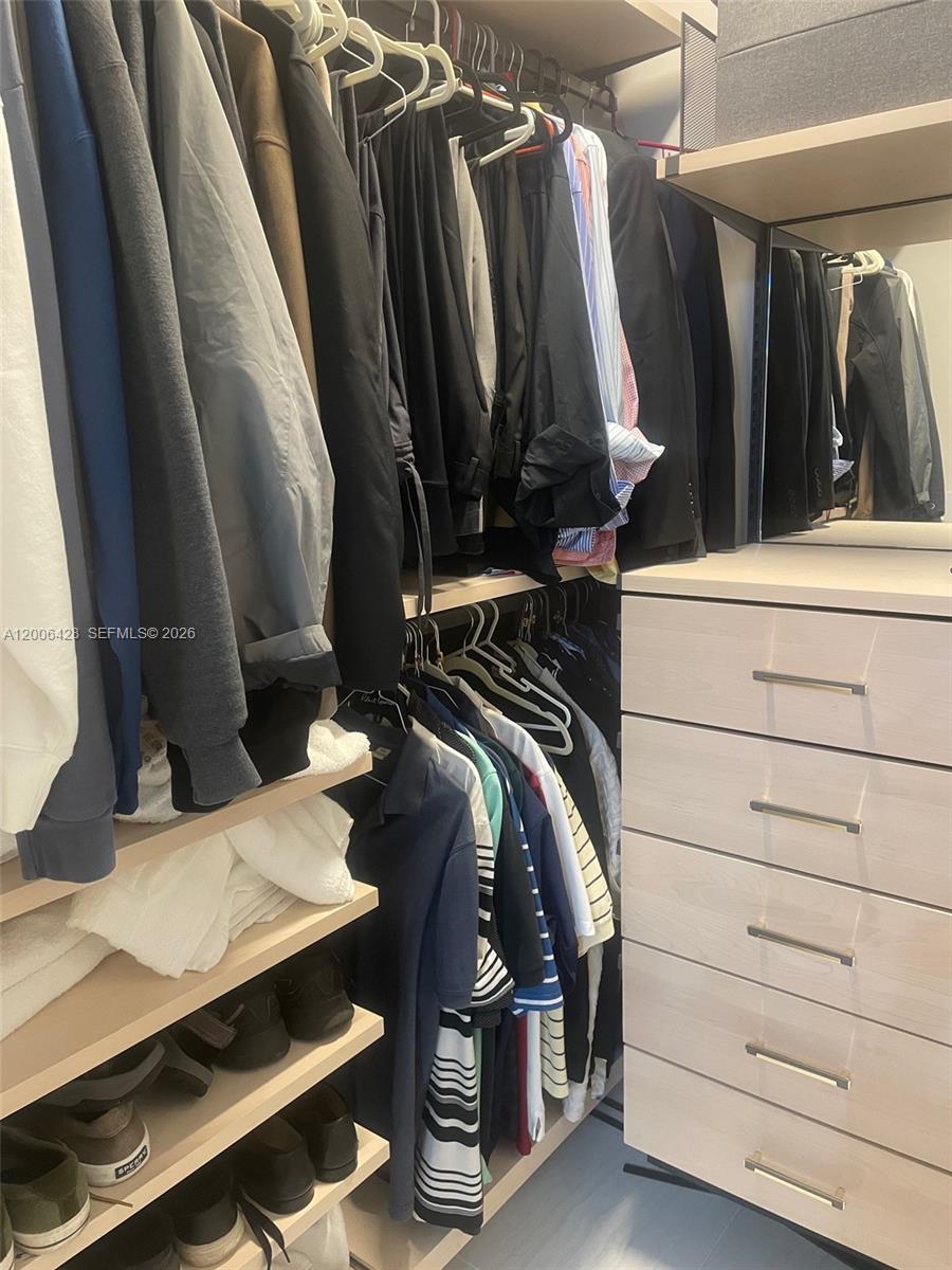 220 Southeast Mizner Boulevard, Unit 321 Boca Raton, FL 33432 - Photo 16 of 24 a view of walk in closet with clothes and shoes
