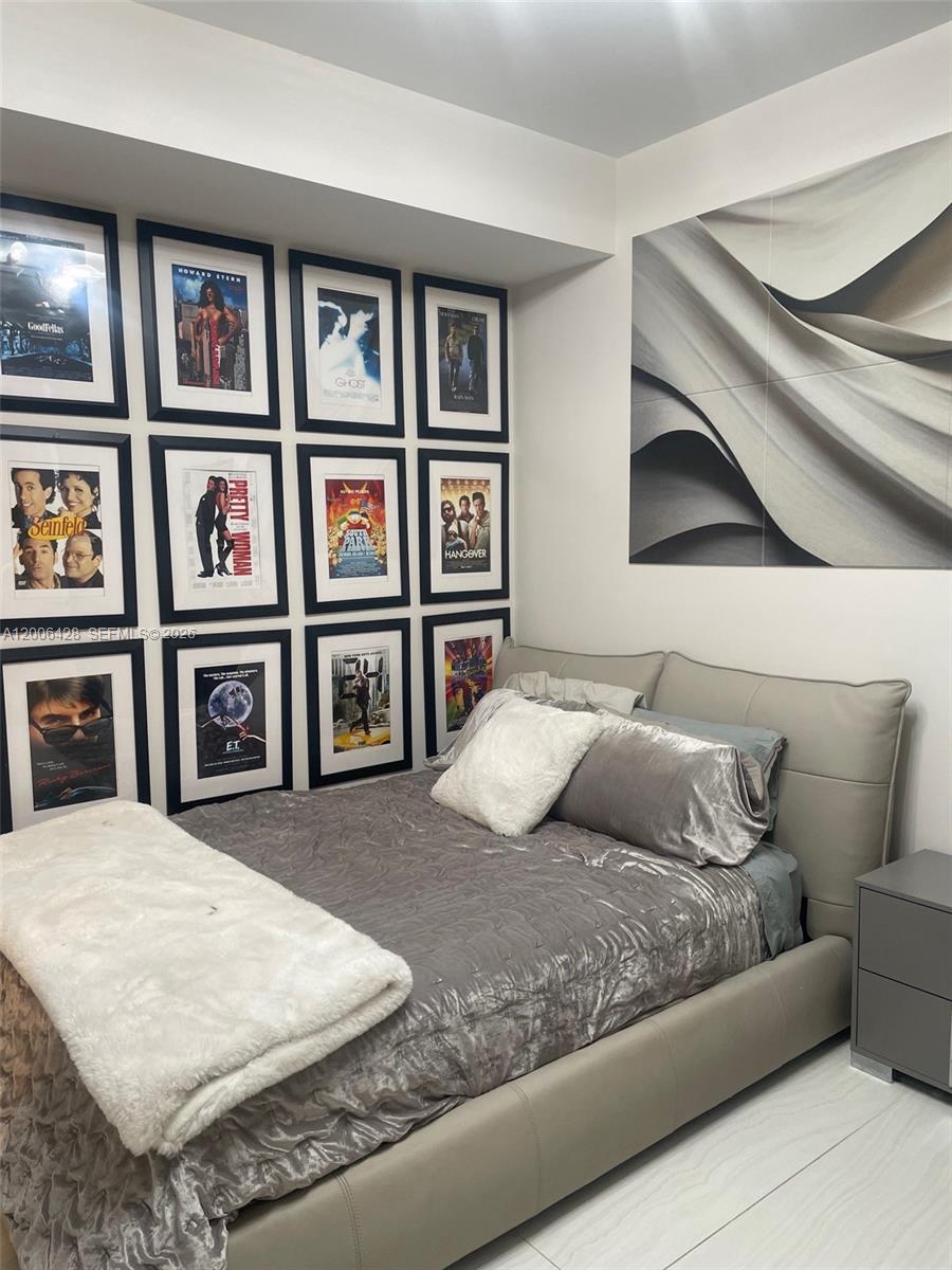 220 Southeast Mizner Boulevard, Unit 321 Boca Raton, FL 33432 - Photo 17 of 24 a bedroom with a bed and a large window