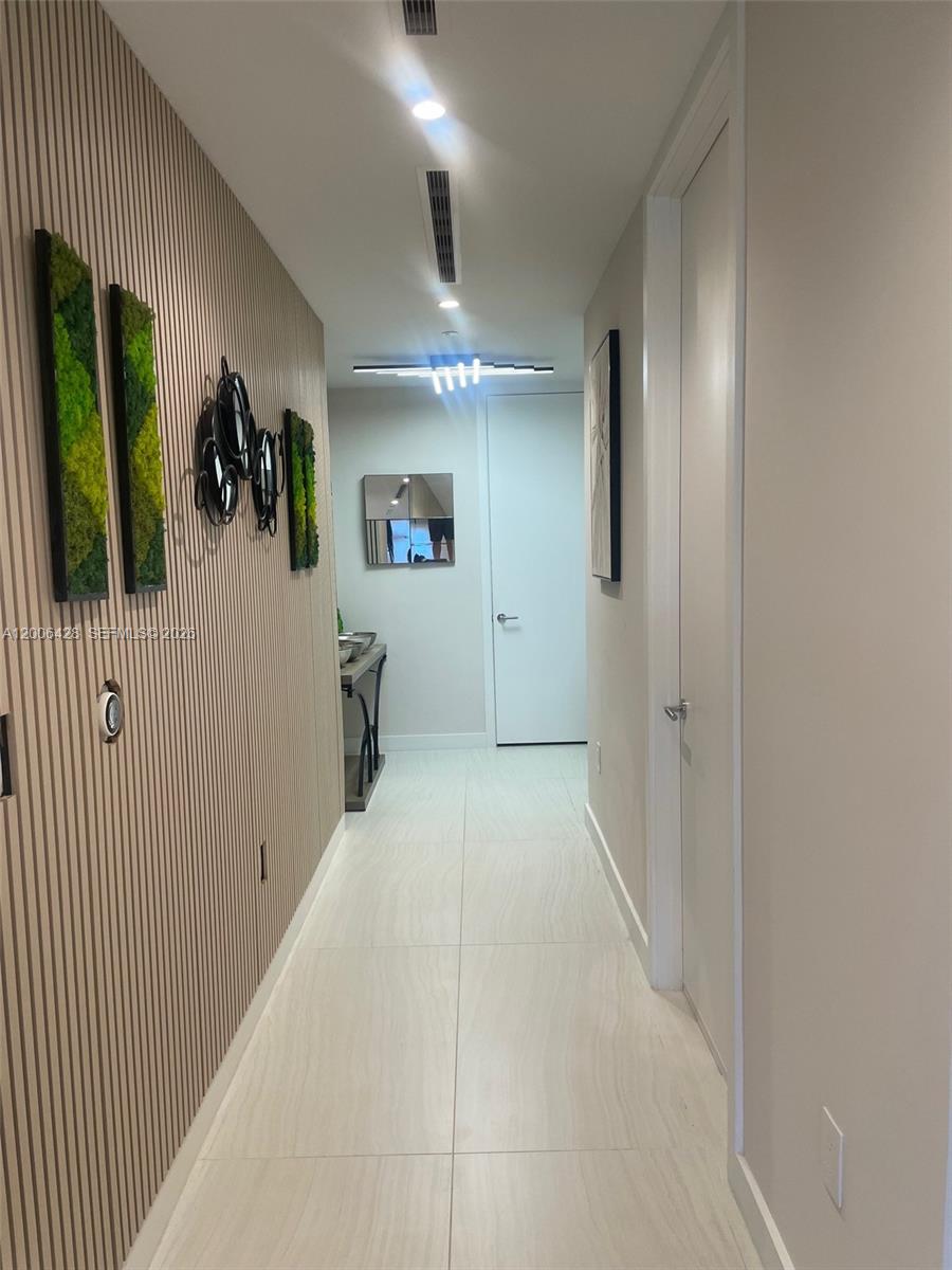 220 Southeast Mizner Boulevard, Unit 321 Boca Raton, FL 33432 - Photo 4 of 24 a view of a hallway with workspace and entryway