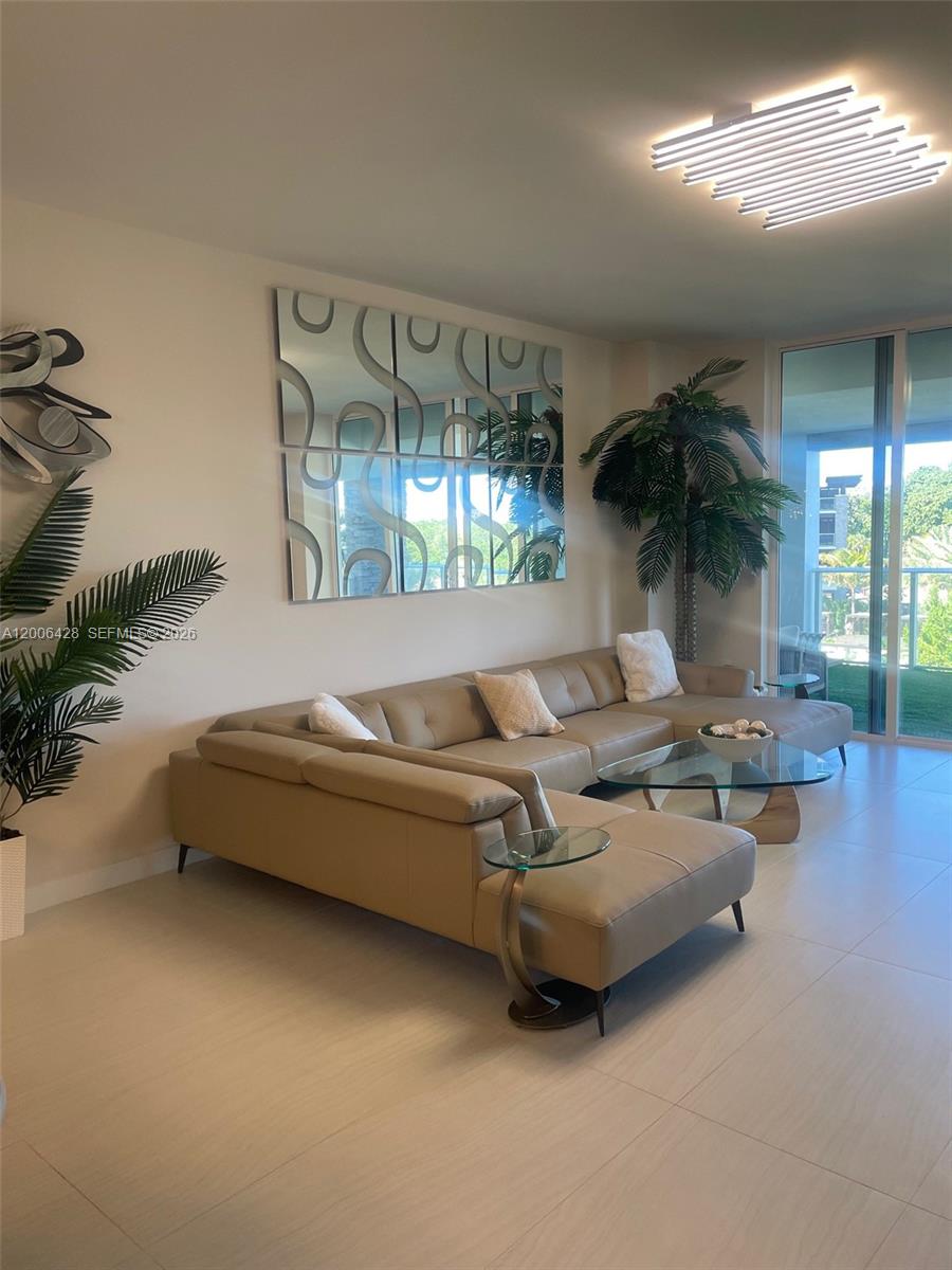 220 Southeast Mizner Boulevard, Unit 321 Boca Raton, FL 33432 - Photo 7 of 24 a living room with furniture and a chandelier