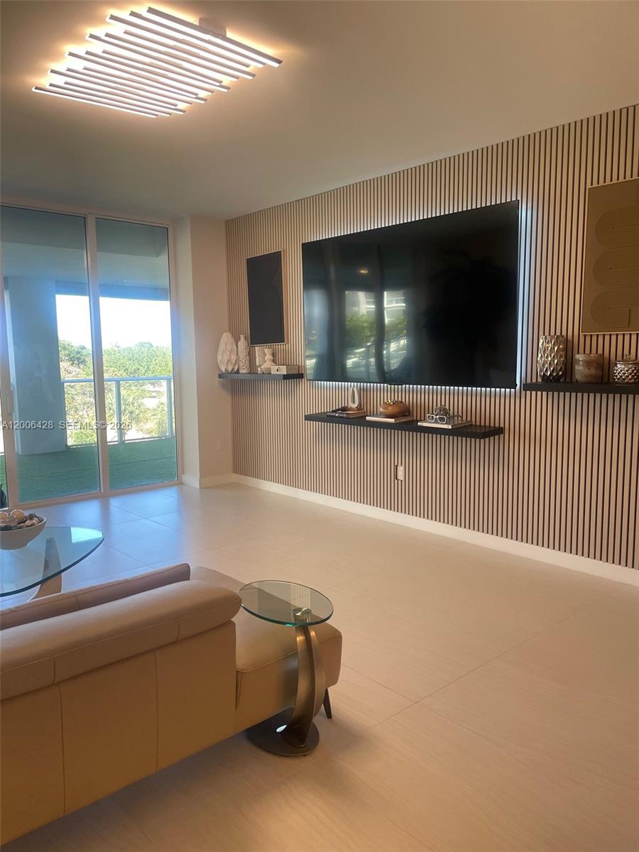 220 Southeast Mizner Boulevard, Unit 321 Boca Raton, FL 33432 - Photo 8 of 24 a living room with furniture and a flat screen tv