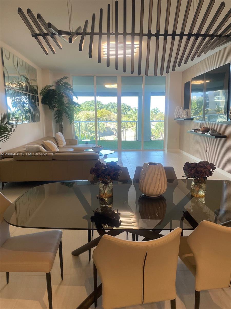 220 Southeast Mizner Boulevard, Unit 321 Boca Raton, FL 33432 - Photo 9 of 24 a living room with furniture and a large window