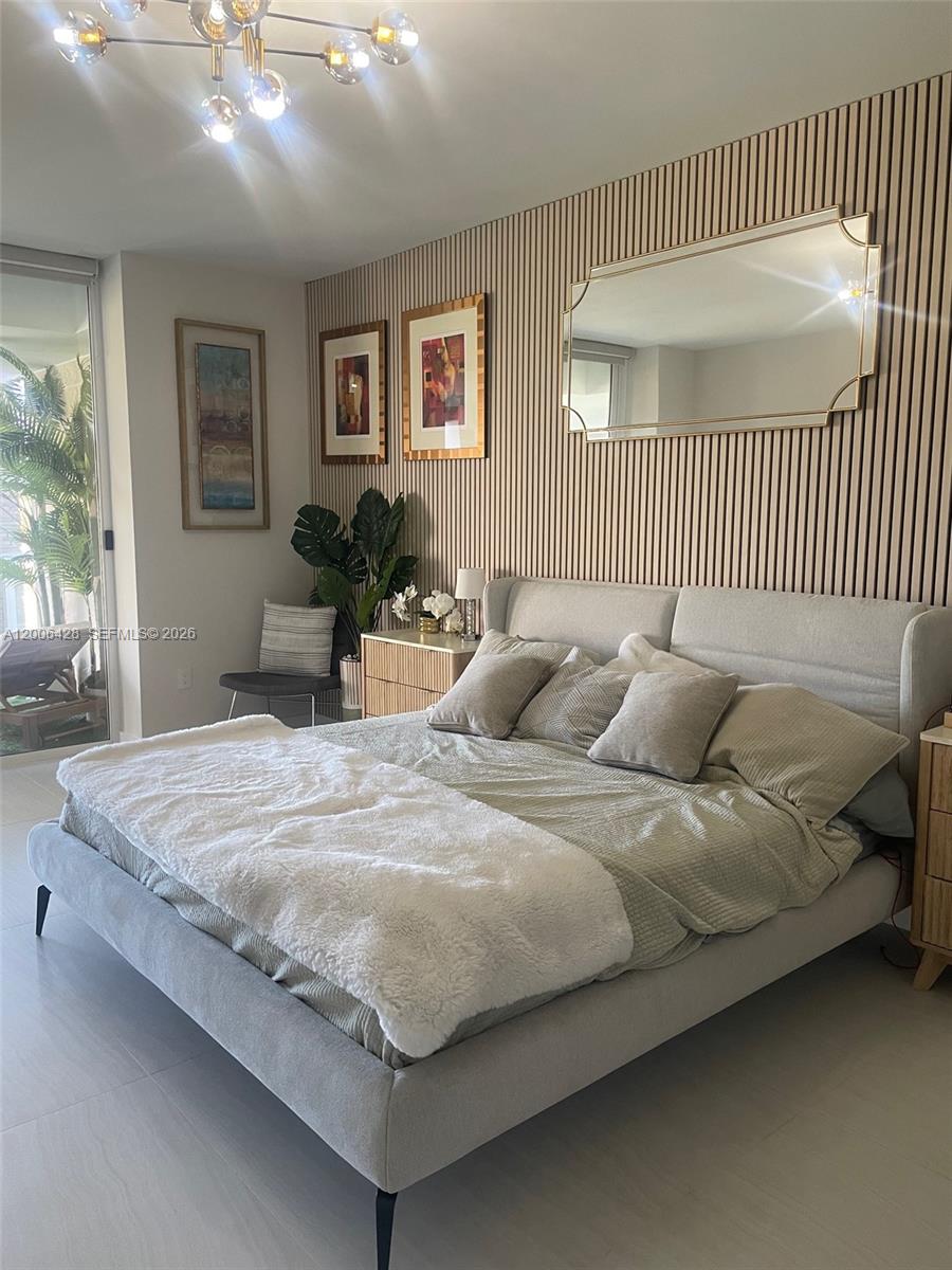 220 Southeast Mizner Boulevard, Unit 321 Boca Raton, FL 33432 - Photo 10 of 24 a bed sitting in a spacious bedroom next to a window