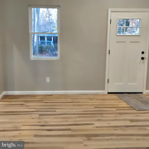 a view of a room with wooden floor and cabinet