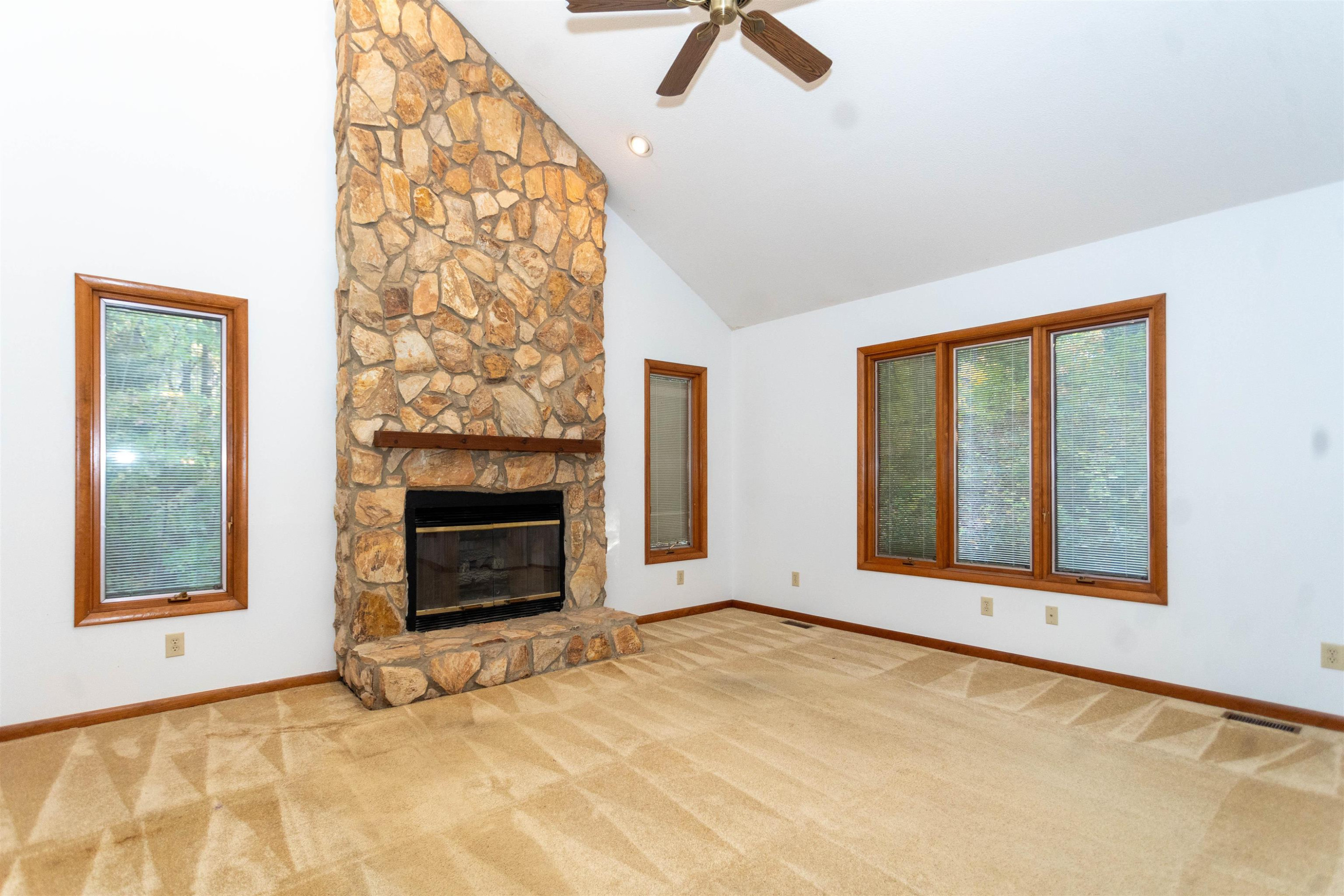 7816 Netherlands Drive Raleigh, NC 27606 - Photo 12 of 60 a view of an empty room with a fireplace and a window