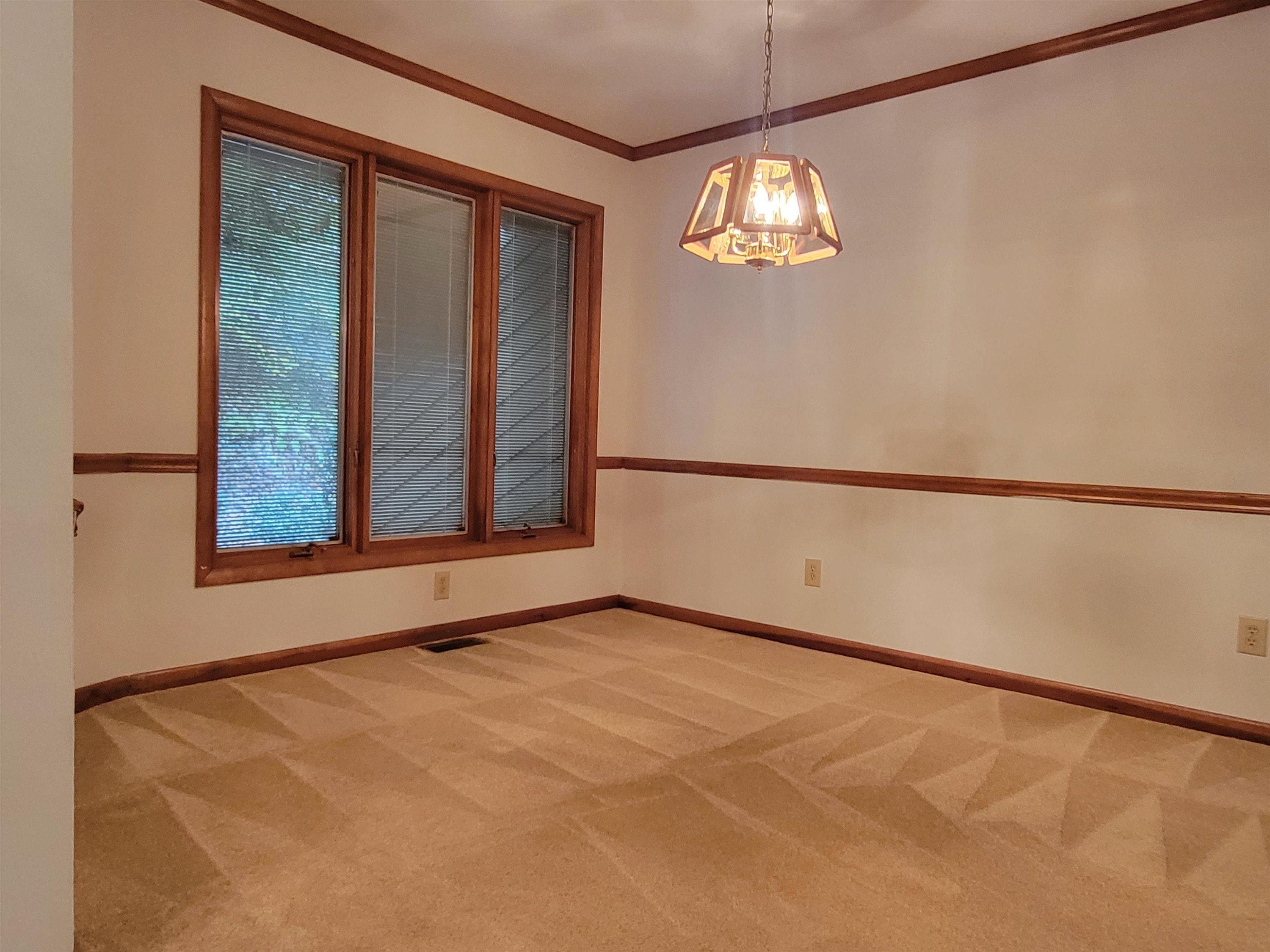 7816 Netherlands Drive Raleigh, NC 27606 - Photo 13 of 60 a view of an empty room with a window