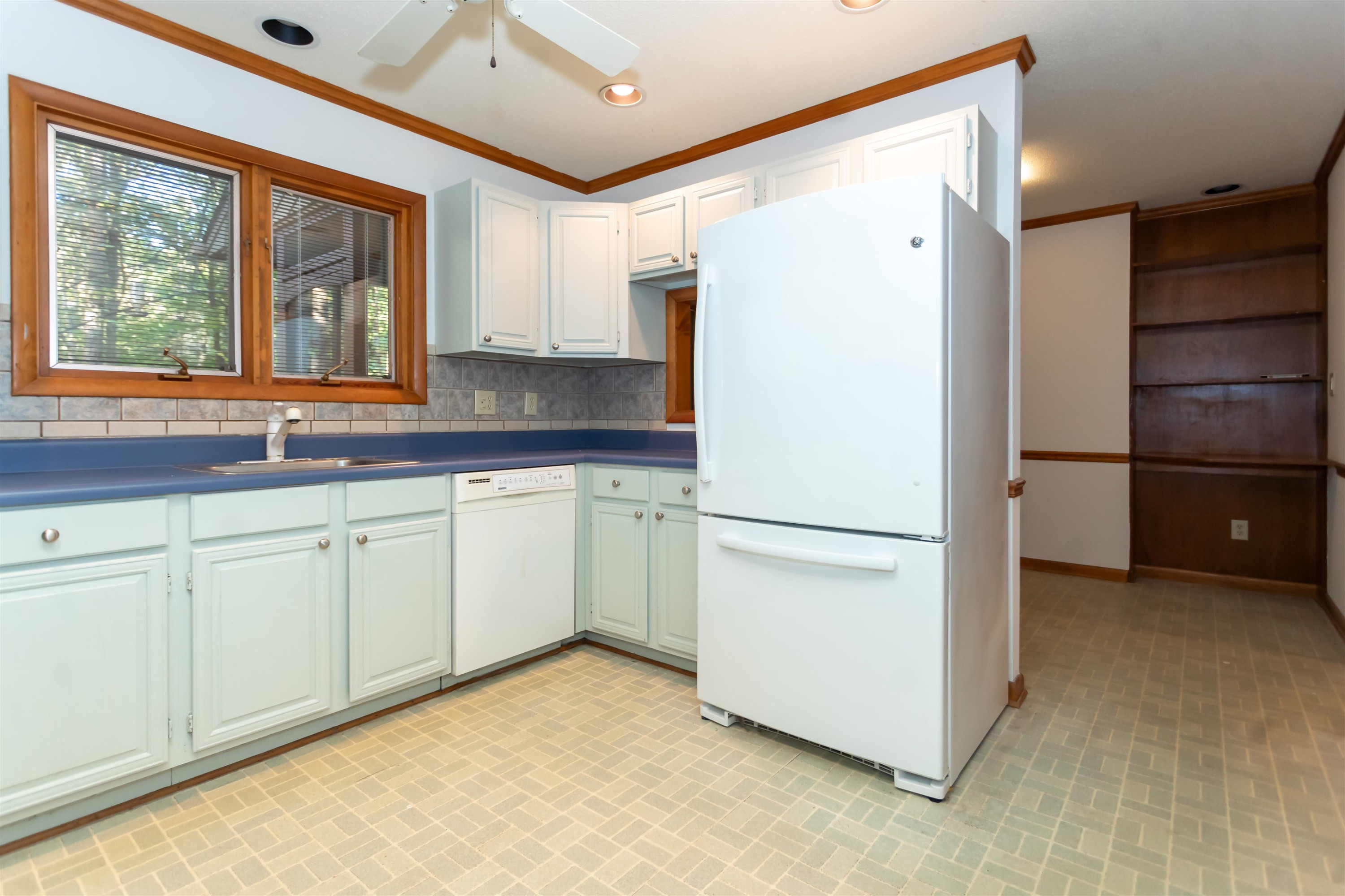 7816 Netherlands Drive Raleigh, NC 27606 - Photo 16 of 60 a white refrigerator freezer sitting inside of a kitchen