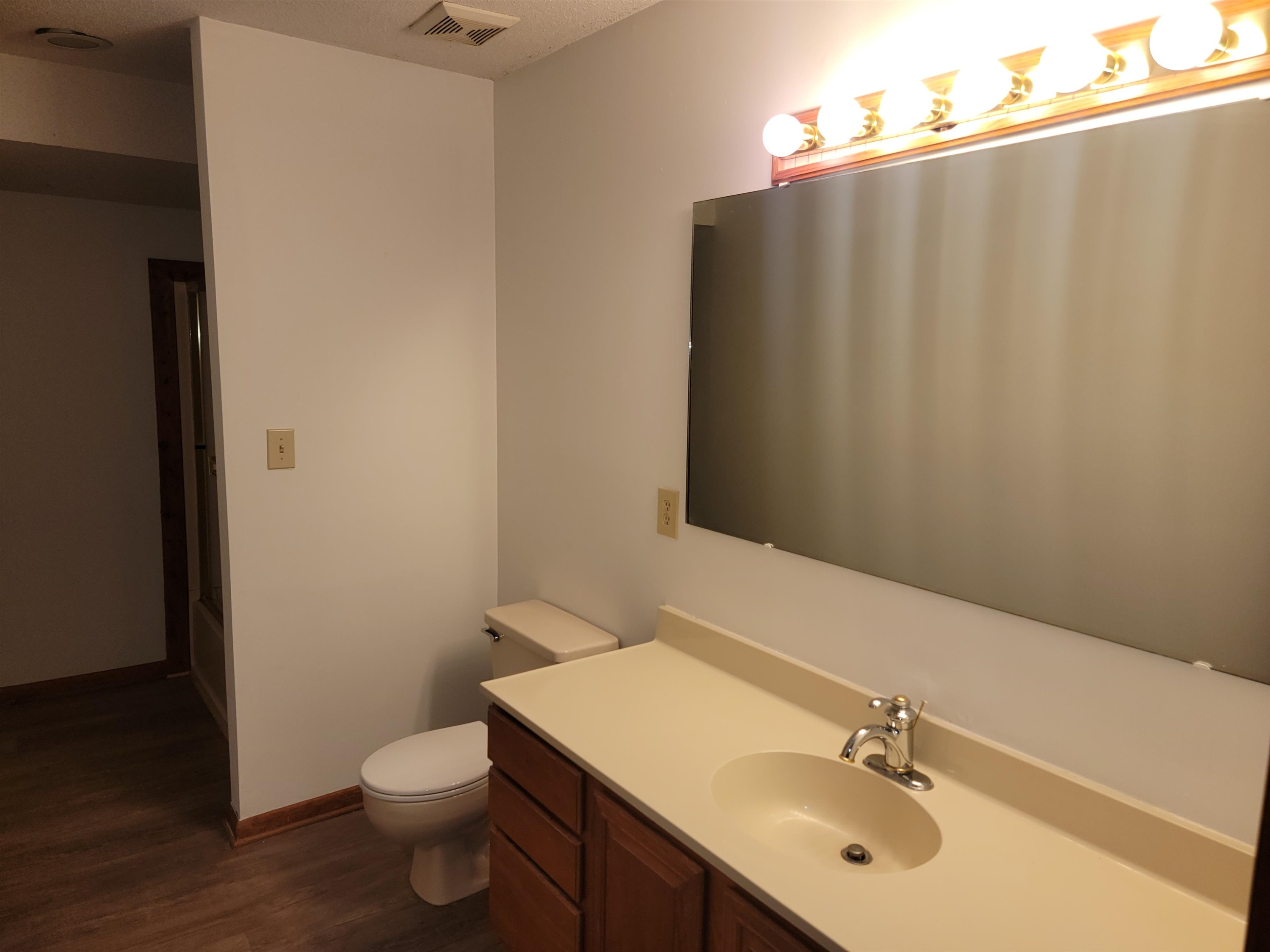 7816 Netherlands Drive Raleigh, NC 27606 - Photo 25 of 60 a bathroom with a sink vanity and toilet
