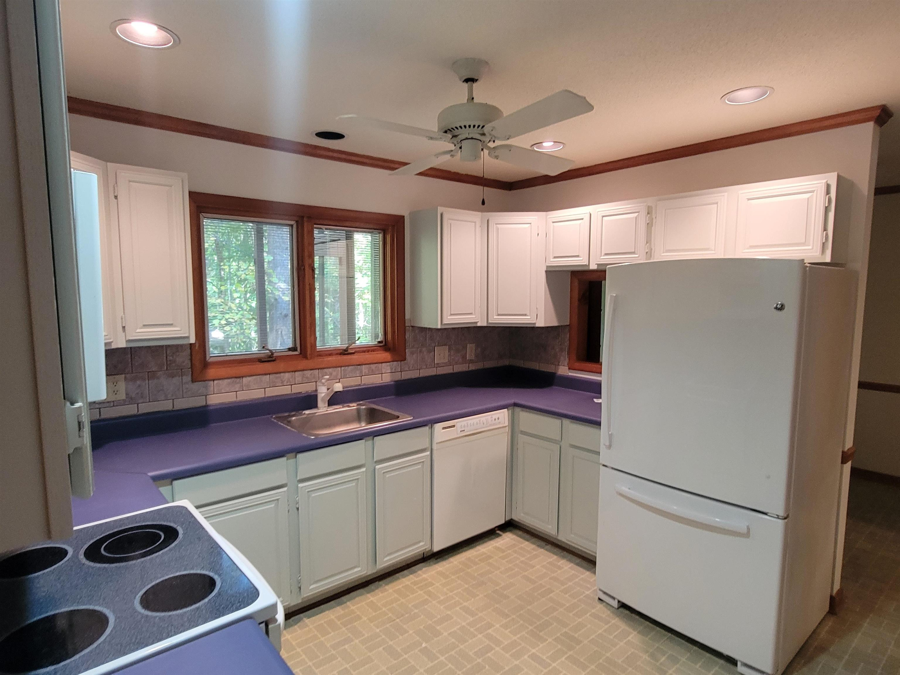 7816 Netherlands Drive Raleigh, NC 27606 - Photo 29 of 60 a kitchen with a refrigerator sink and cabinets