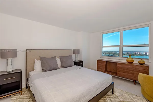 a bedroom with a large bed and a window