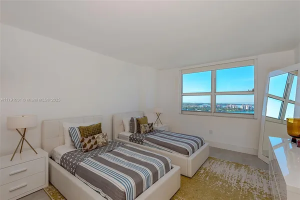 a bedroom with furniture and a window