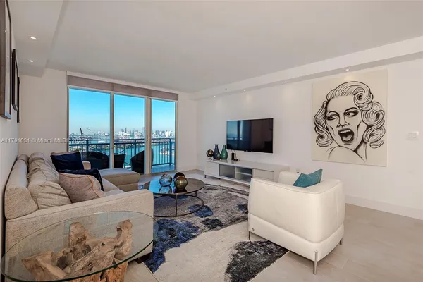 a living room with furniture a rug and a flat screen tv