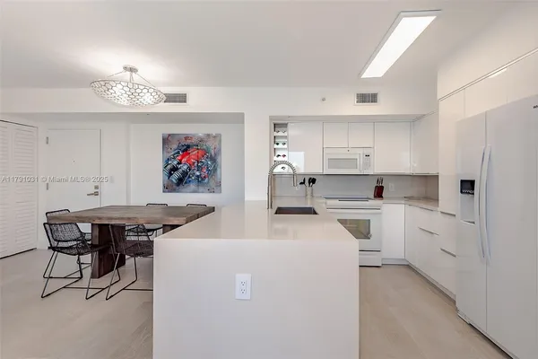 a view of kitchen with cabinets and wooden floor