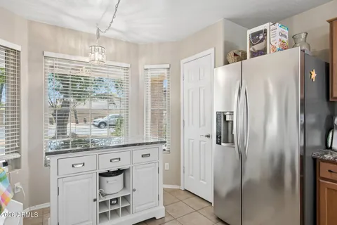 a kitchen with stainless steel appliances a refrigerator and a window