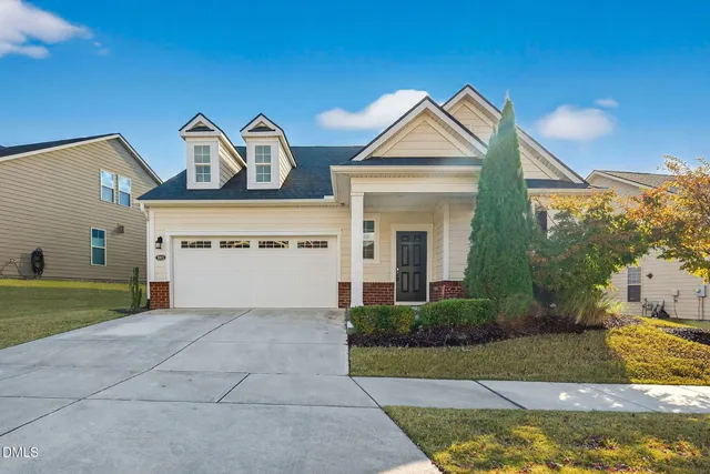 a view of a house with a yard and garage