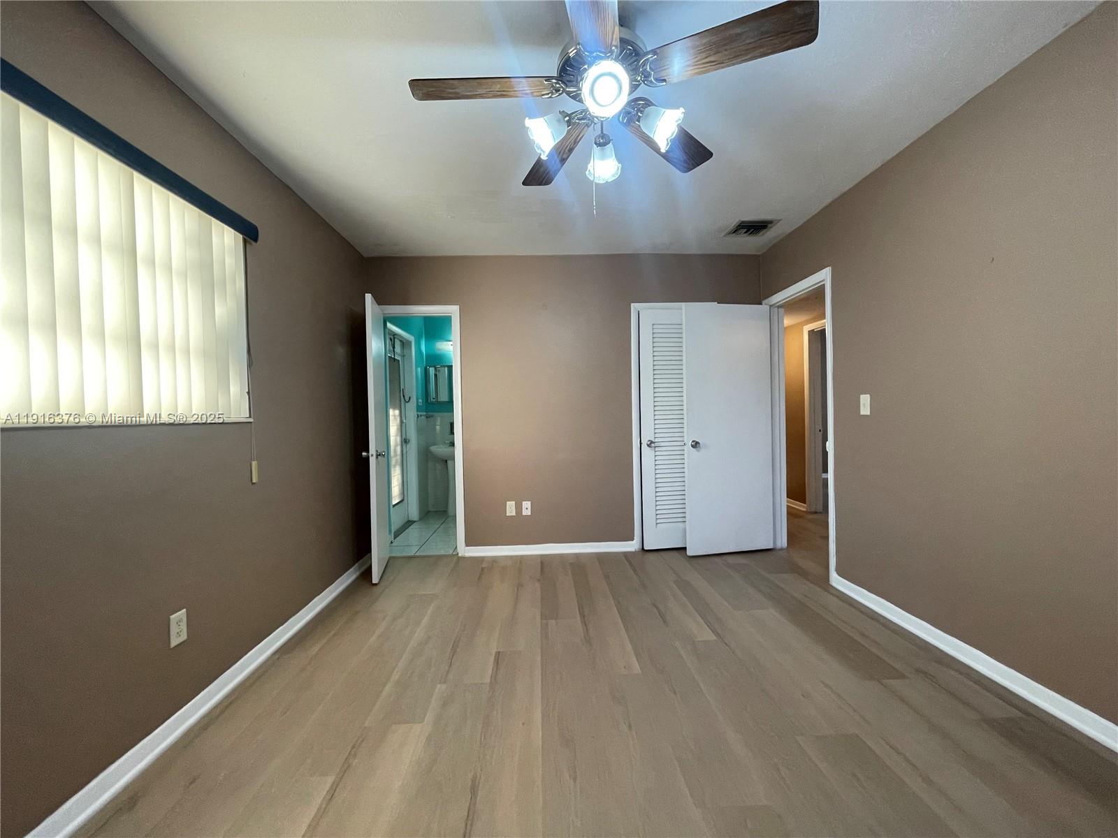 19700 Whispering Pines Road Cutler Bay, FL 33157 - Photo 16 of 27 wooden floor in an empty room with a window