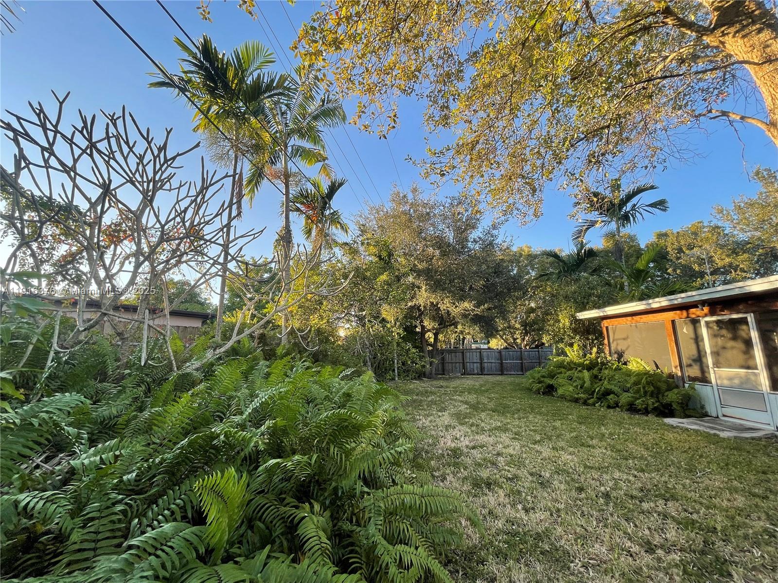 19700 Whispering Pines Road Cutler Bay, FL 33157 - Photo 22 of 27 a backyard of a house with lots of green space