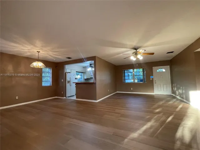 a view of empty room with window and fireplace