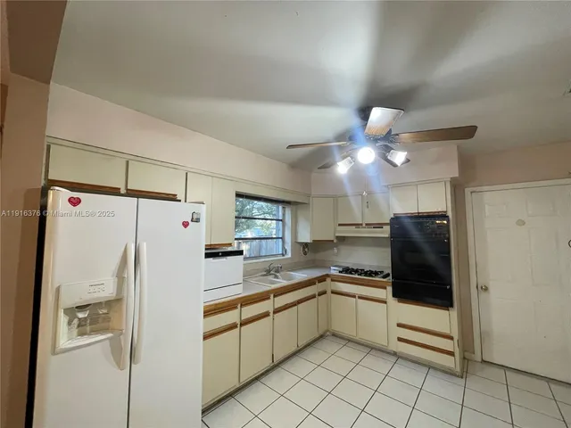 a kitchen with a refrigerator a sink and dishwasher