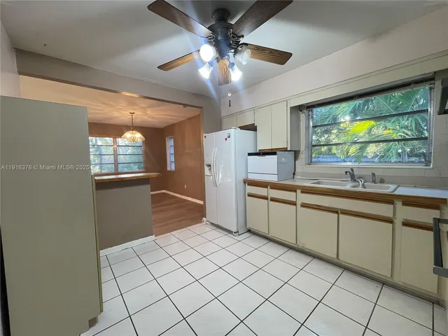 a kitchen with a sink and refrigerator