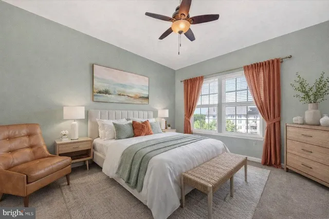 a bedroom with a bed a couch and a window