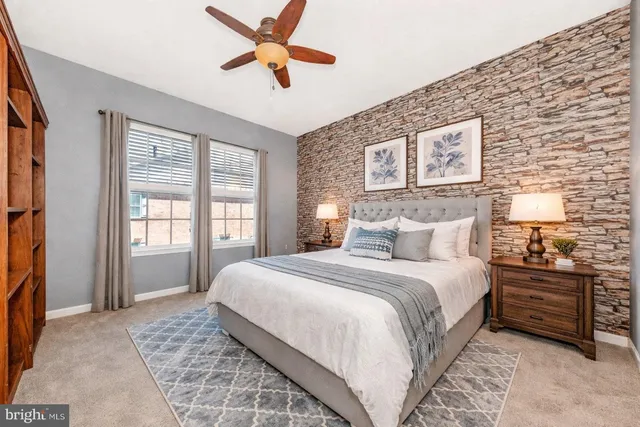 a bedroom with a large bed and a window