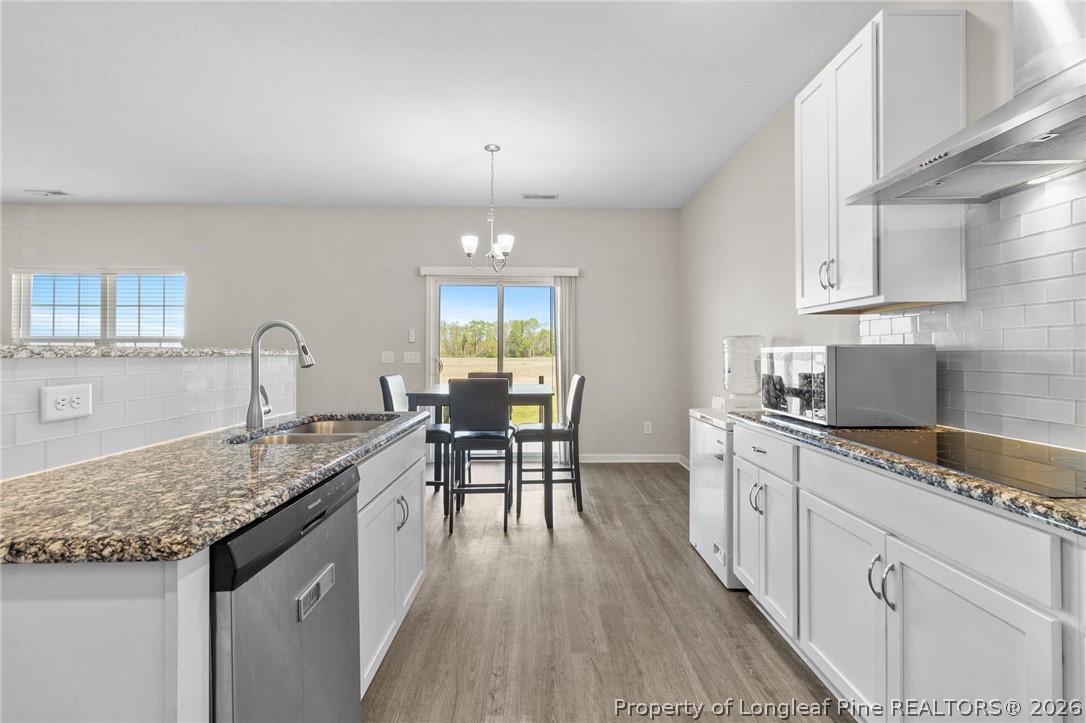 3298 Deep Branch Road Lumberton, NC 28360 - Photo 11 of 41 a kitchen with granite countertop sink stove and dining table