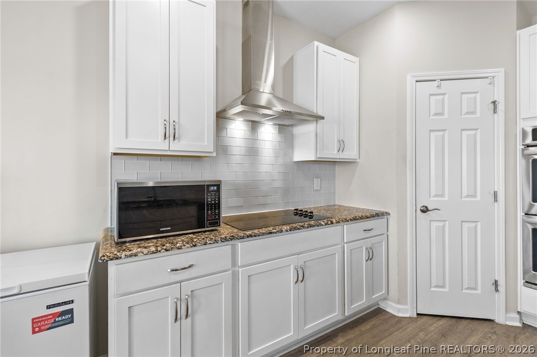 3298 Deep Branch Road Lumberton, NC 28360 - Photo 12 of 41 a kitchen with granite countertop white cabinets and white appliances