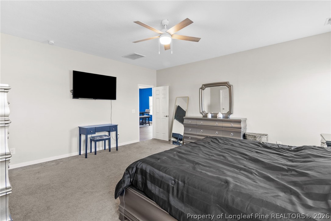 3298 Deep Branch Road Lumberton, NC 28360 - Photo 17 of 41 a bedroom with a bed a television and a desk