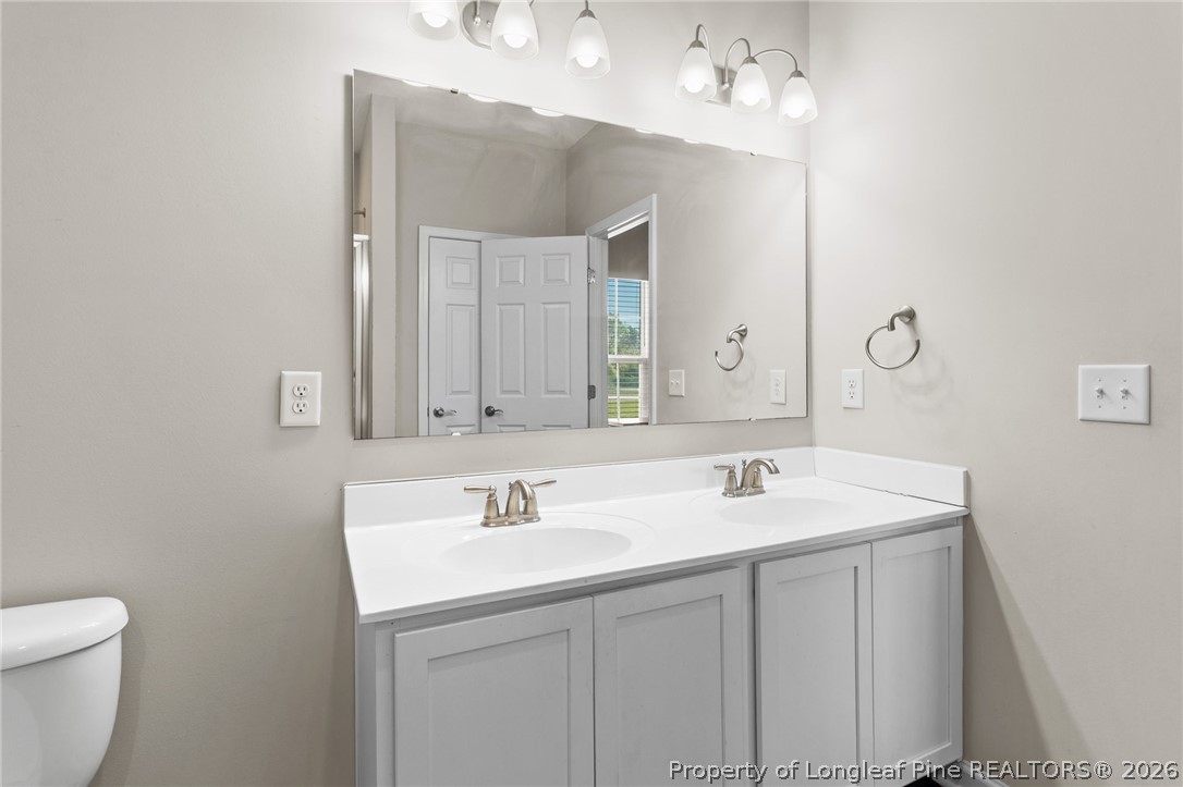 3298 Deep Branch Road Lumberton, NC 28360 - Photo 19 of 41 a bathroom with a sink vanity and a mirror