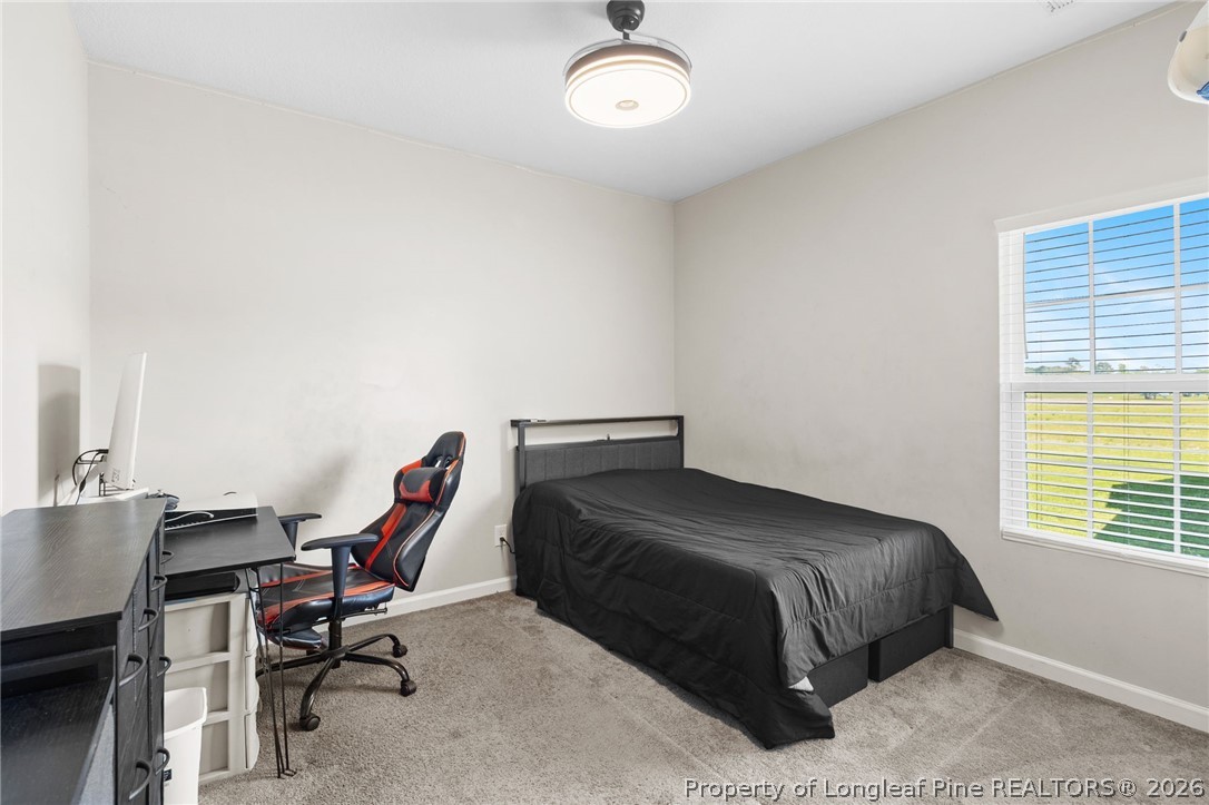 3298 Deep Branch Road Lumberton, NC 28360 - Photo 26 of 41 a bedroom with a bed and a desk