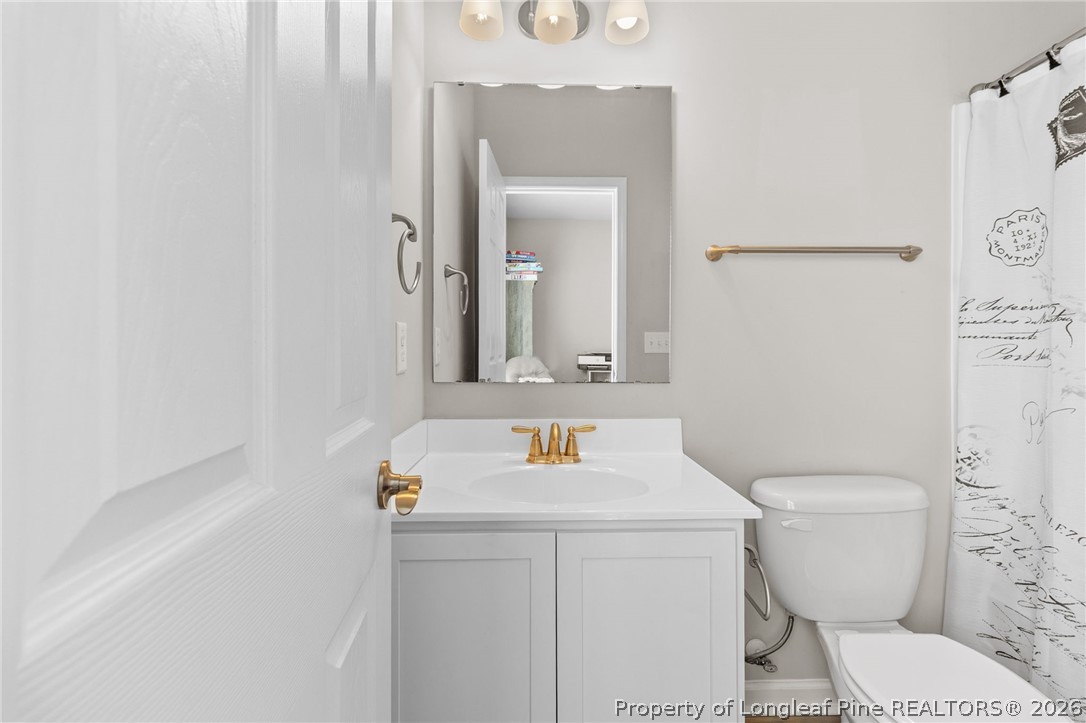 3298 Deep Branch Road Lumberton, NC 28360 - Photo 30 of 41 a bathroom with a sink toilet and mirror
