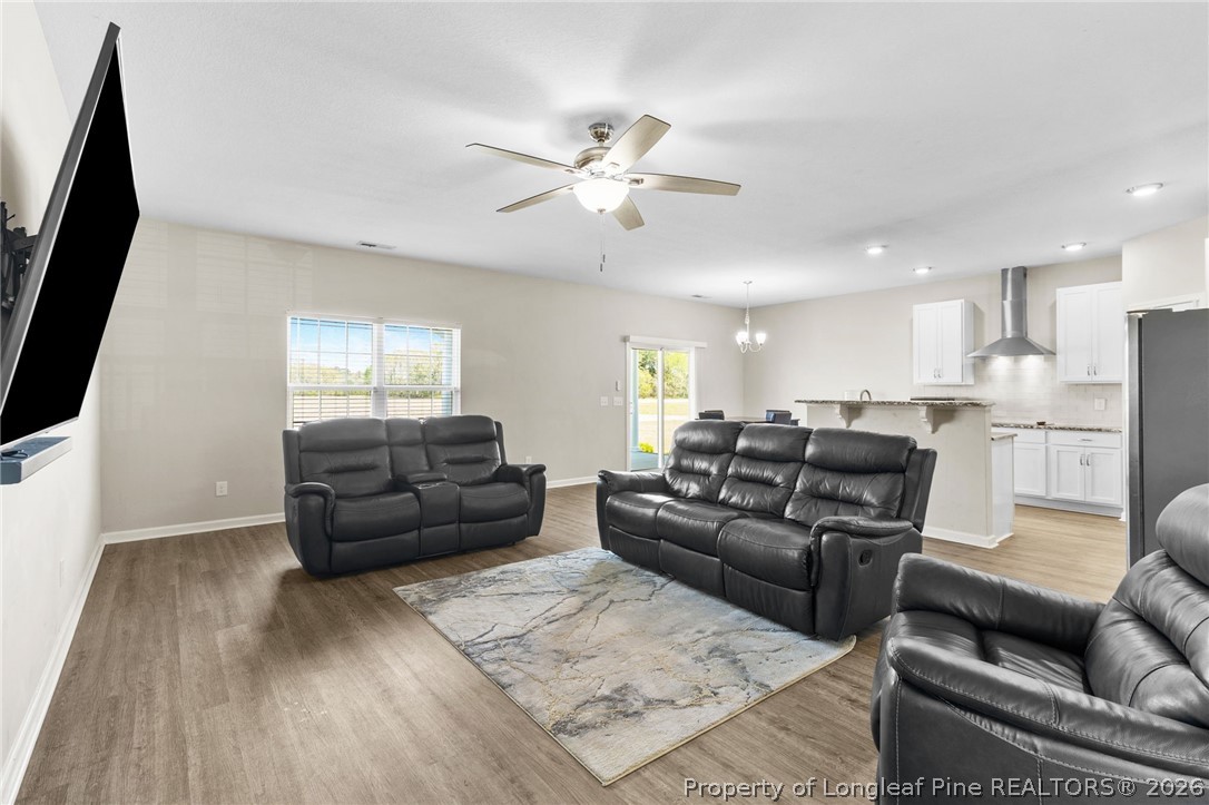 3298 Deep Branch Road Lumberton, NC 28360 - Photo 6 of 41 a living room with furniture and a flat screen tv