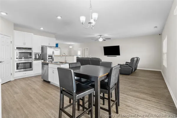 a kitchen with granite countertop sink stove and dining table