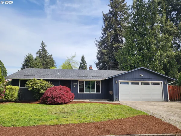 a front view of a house with a garden and yard