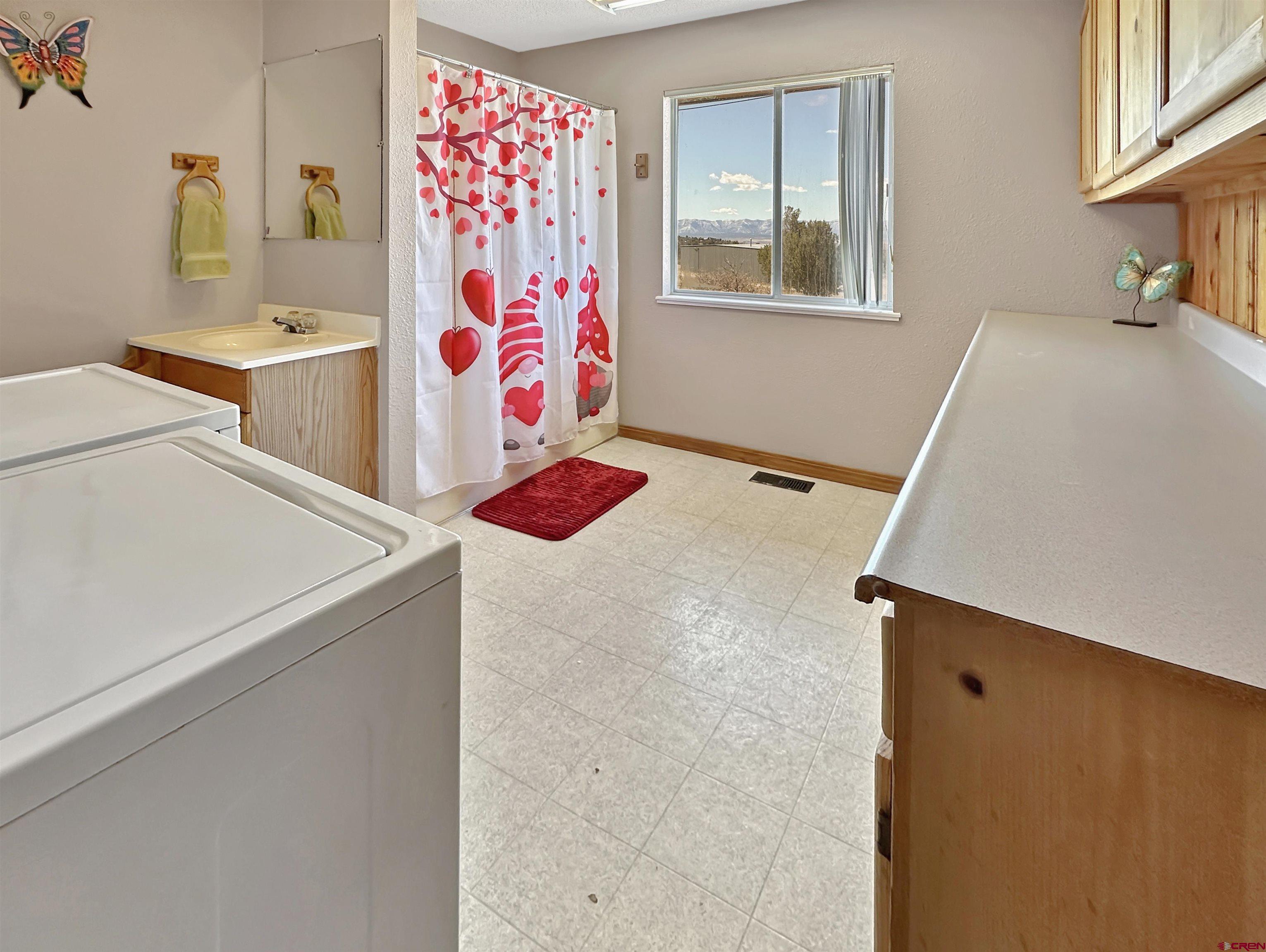 27980 Rd T Dolores, CO 81323 - Photo 11 of 29 a bathroom with a tub sink and mirror