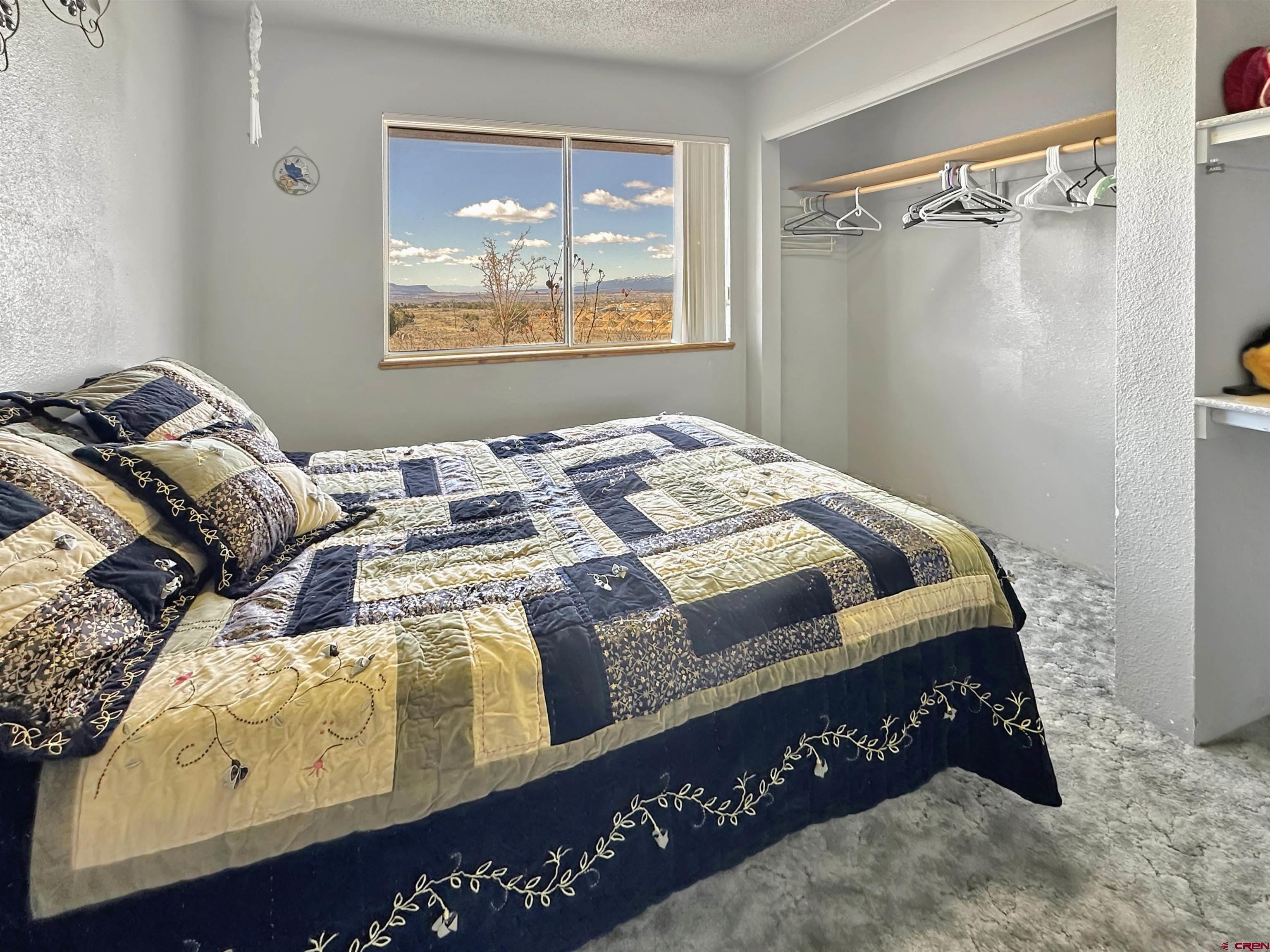 27980 Rd T Dolores, CO 81323 - Photo 12 of 29 a bed sitting in a bedroom next to a window