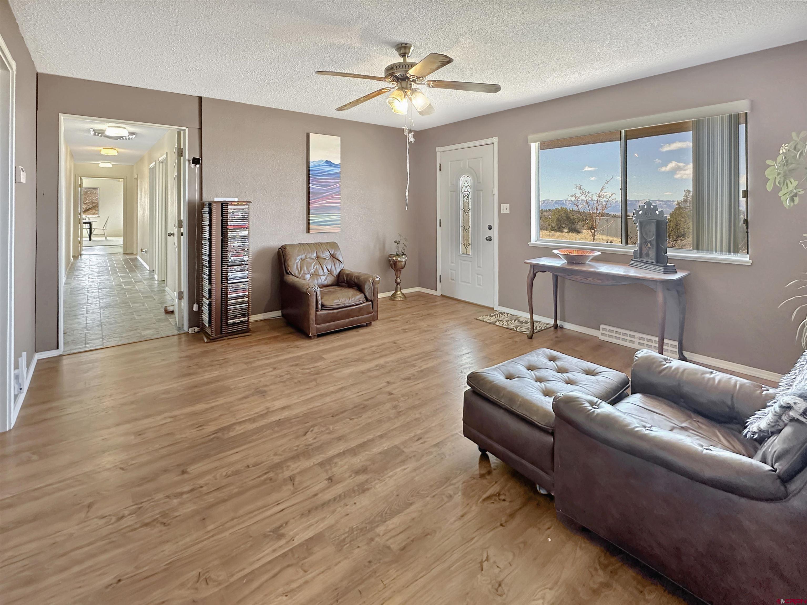 27980 Rd T Dolores, CO 81323 - Photo 13 of 29 a living room with furniture and a chandelier