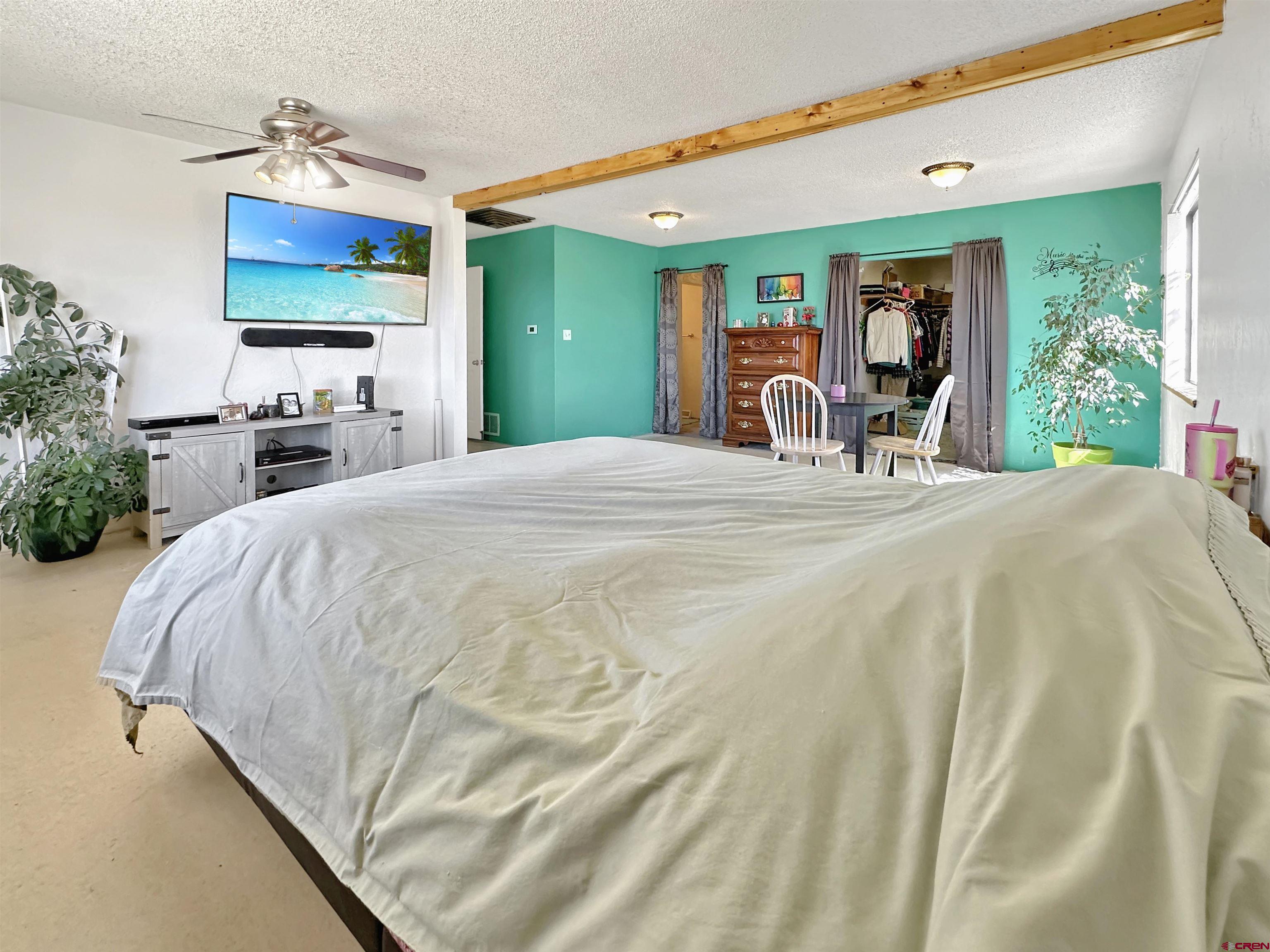 27980 Rd T Dolores, CO 81323 - Photo 19 of 29 a bed sitting in a bedroom next to a window